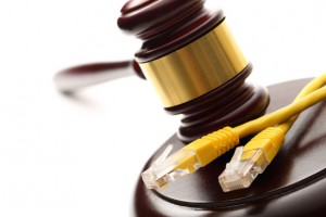 Yellow ethernet cable and wooden gavel